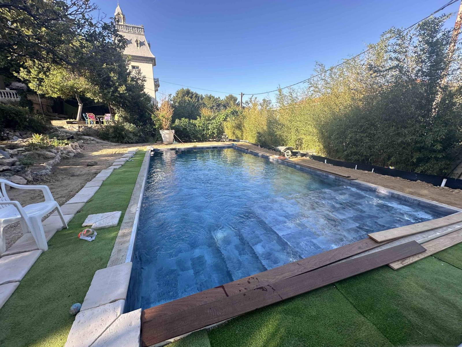 Construction d'une piscine 10mx5m en béton armé avec un revêtement liner pvc armé HAOGENPLAST STONETILE imitation pierre de Bali